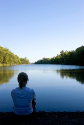 woman meditating at lake small